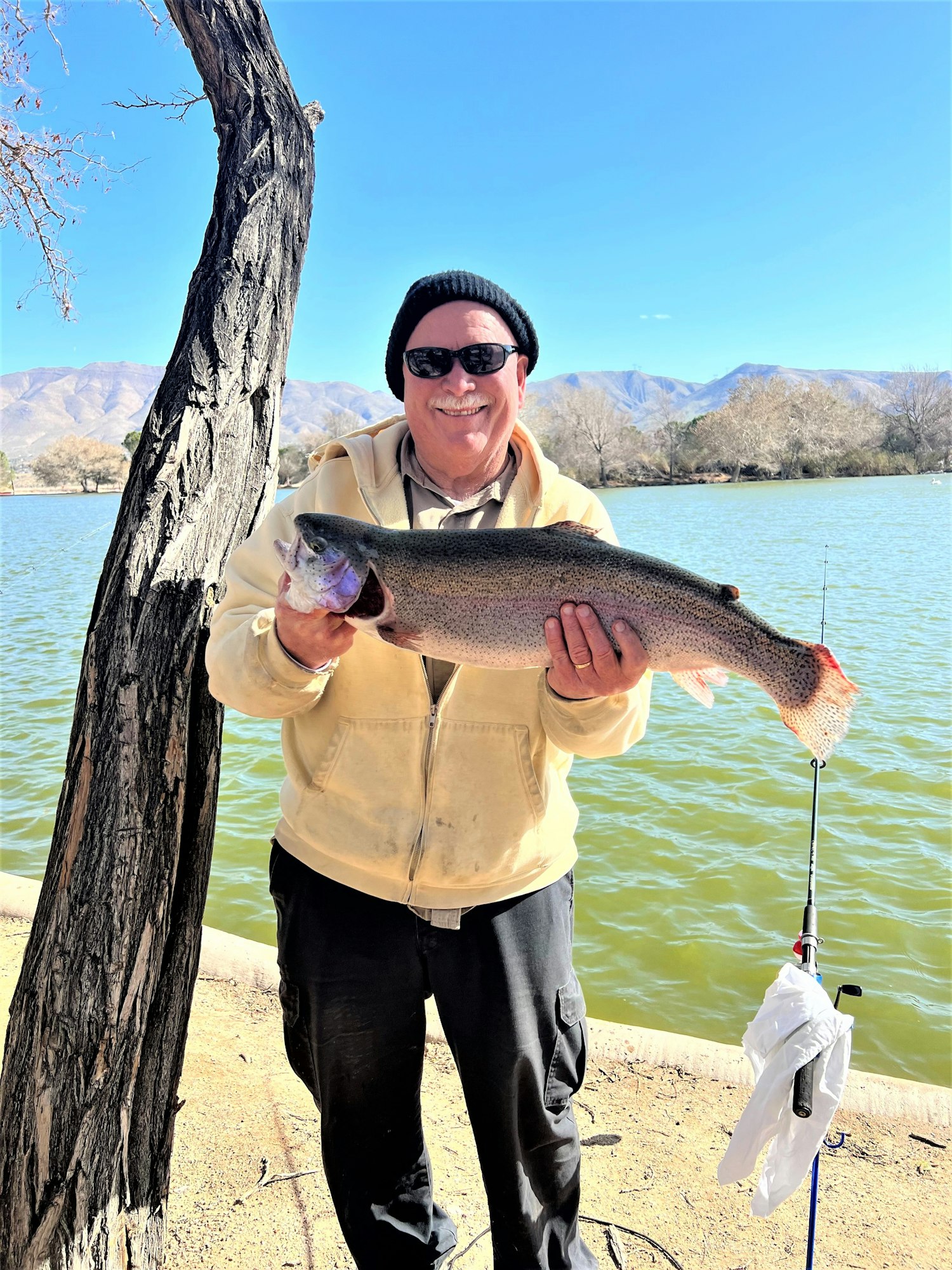 May contain: fish, sea life, animal, coho, trout, person, fishing, outdoors, water, leisure activities, portrait, photography, head, face, hat, clothing, glasses, accessories, and glove