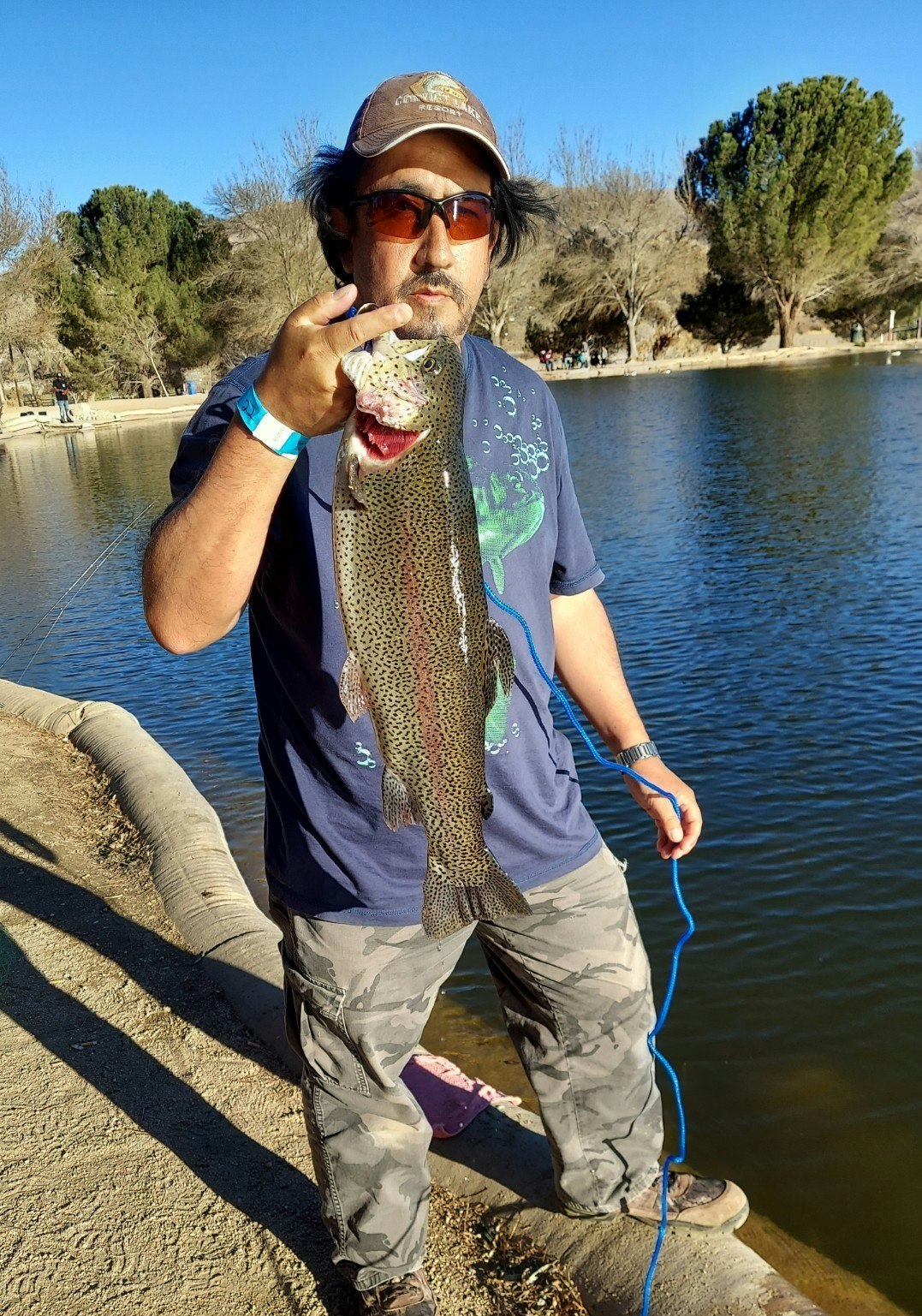May contain: person, human, sunglasses, accessories, accessory, trout, fish, and animal