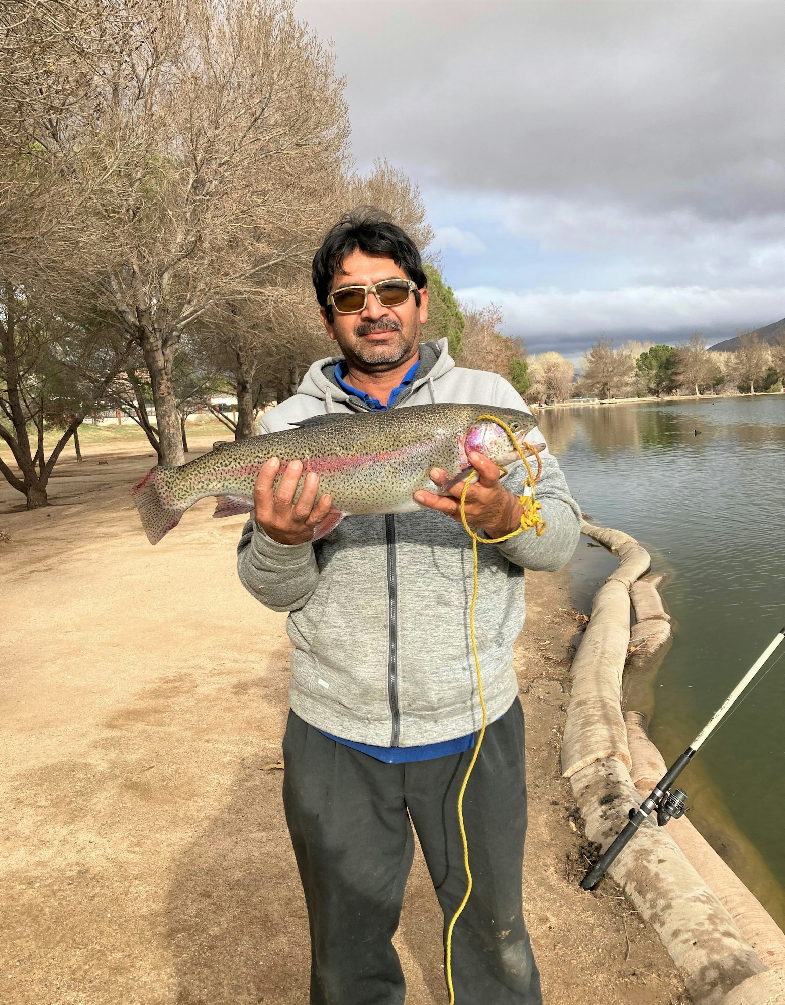 May contain: portrait, photography, person, head, face, fishing, outdoors, water, leisure activities, trout, fish, sea life, animal, glasses, accessories, soil, man, adult, and male