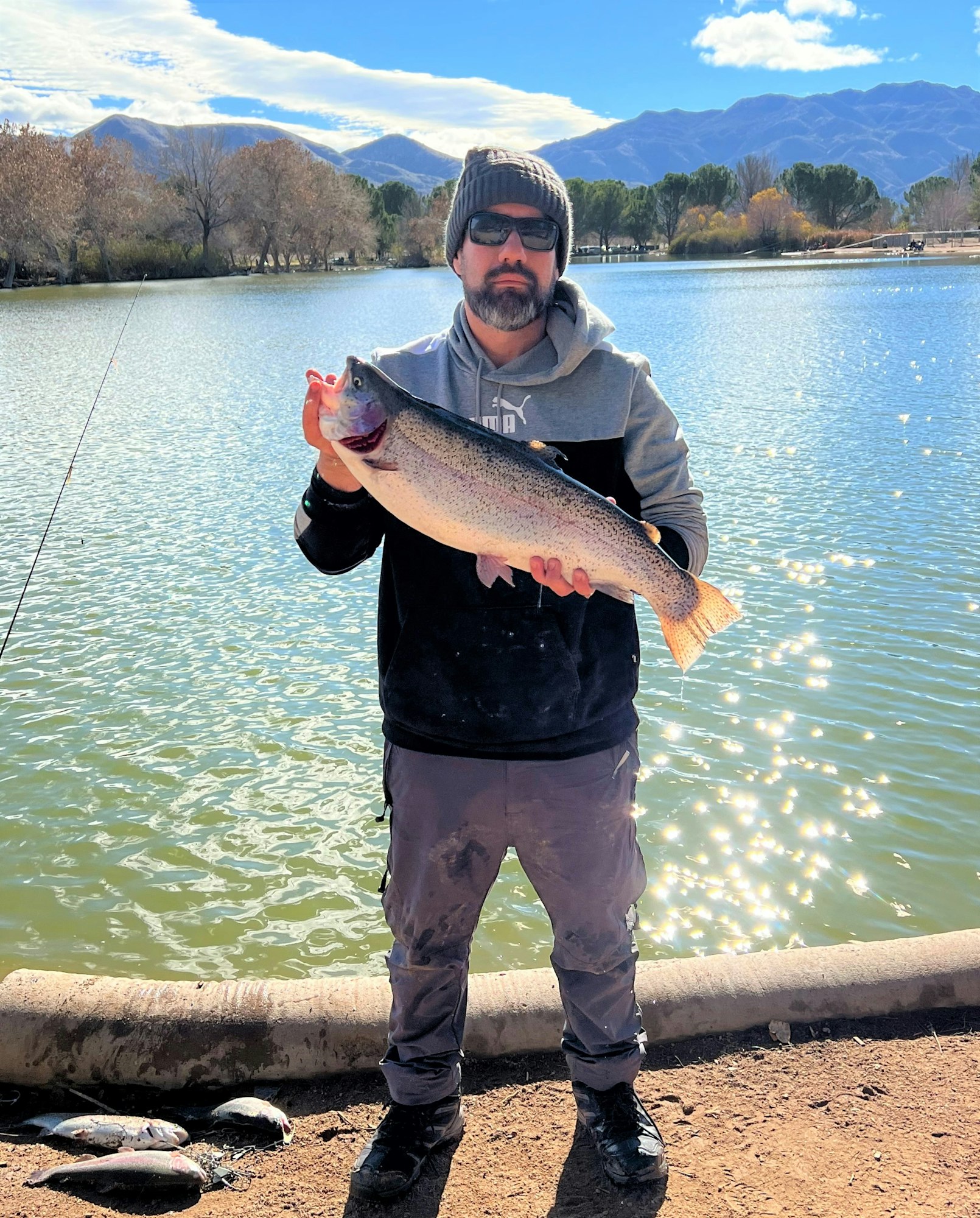May contain: portrait, photography, person, head, face, fish, sea life, animal, coho, fishing, outdoors, water, leisure activities, lake, nature, trout, glasses, accessories, soil, bonito, tuna, shoe, footwear, and clothing