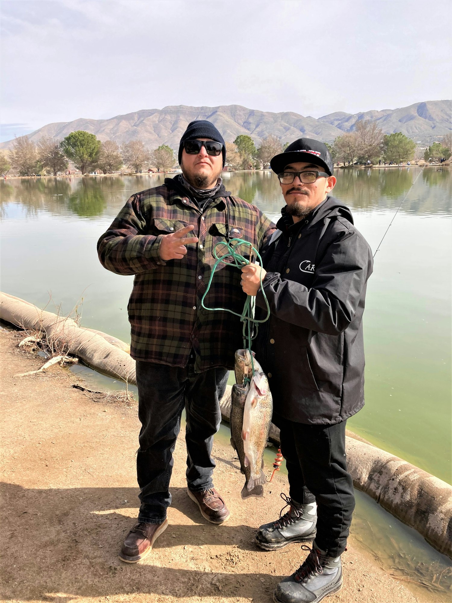 May contain: fishing, outdoors, water, leisure activities, photography, shoe, footwear, clothing, portrait, person, head, face, glasses, accessories, man, adult, male, coat, pants, bonito, tuna, sea life, fish, animal, and coho