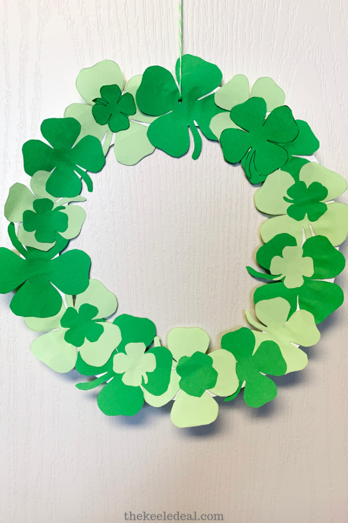 Paper plate wreath with paper four leaf clovers covering it