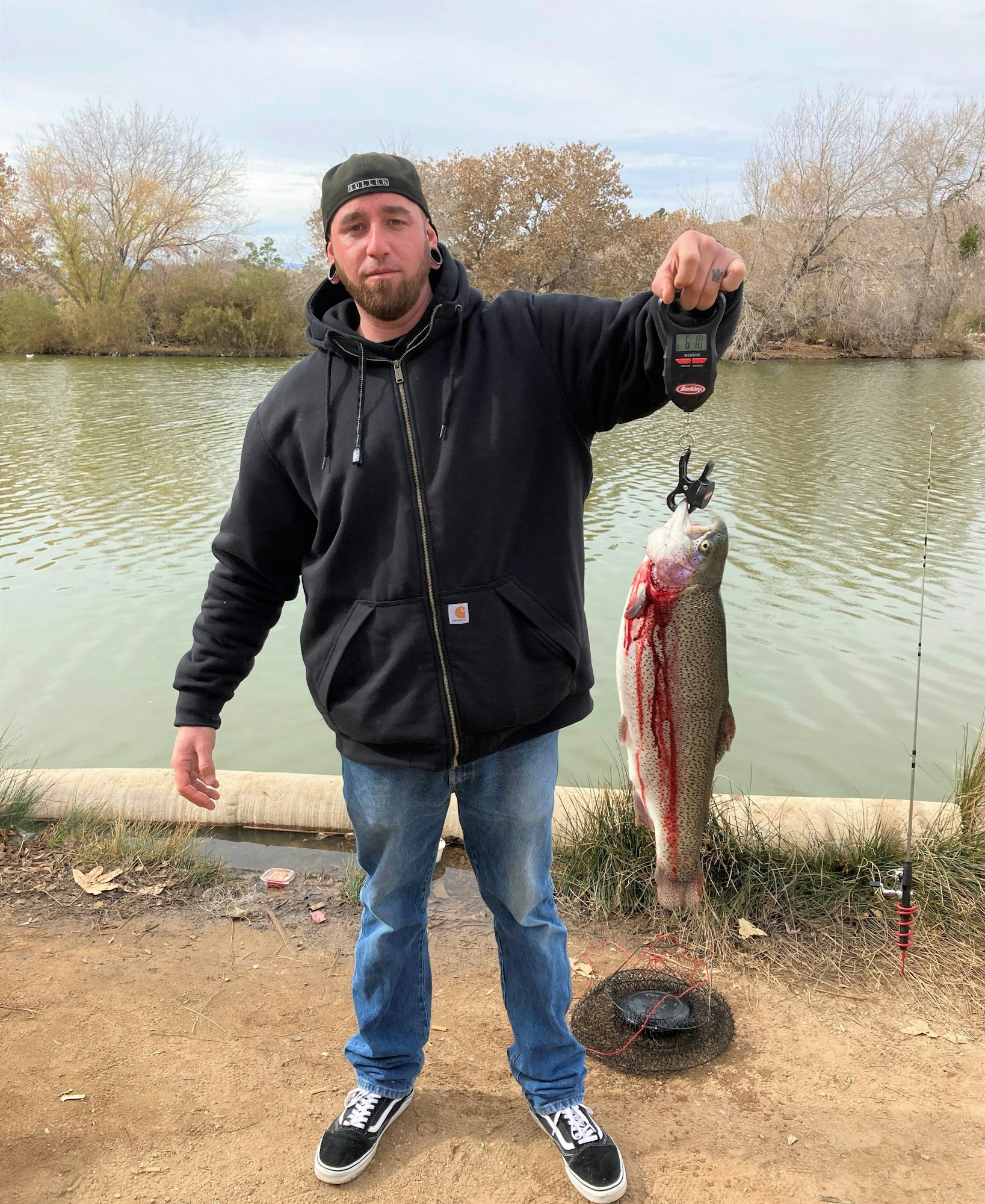 May contain: pants, clothing, portrait, photography, person, head, face, fishing, outdoors, water, leisure activities, shoe, footwear, soil, jacket, coat, jeans, fish, sea life, animal, man, adult, male, tree, plant, bonito, tuna, lake, nature, hoodie, sweatshirt, sweater, knitwear, trout, waterfront, pond, and vegetation