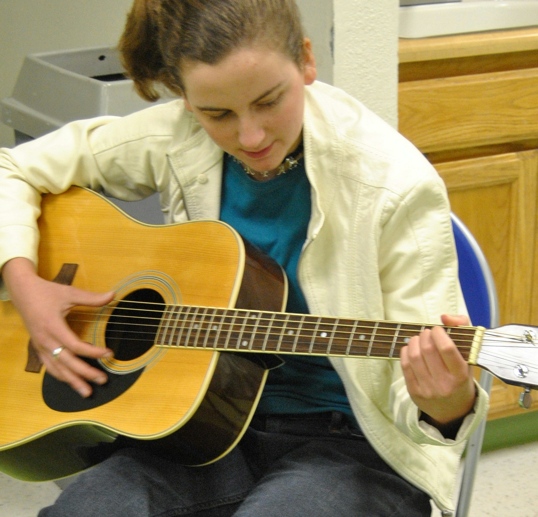 May contain: guitar, leisure activities, musical instrument, person, and human