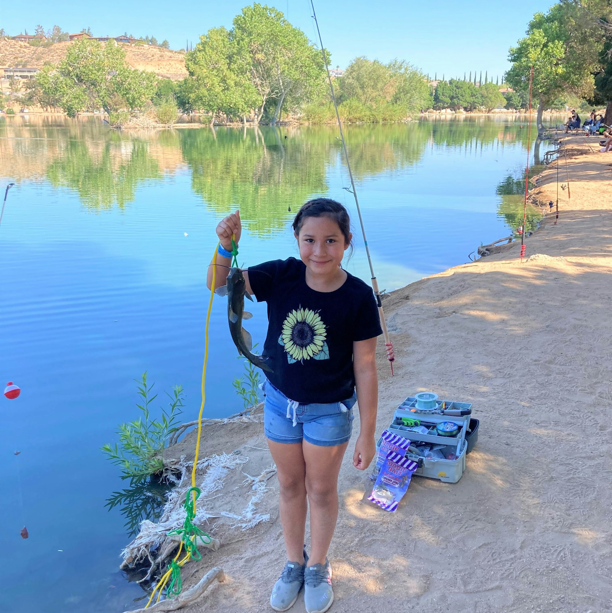 May contain: water, outdoors, person, human, clothing, apparel, shorts, and fishing