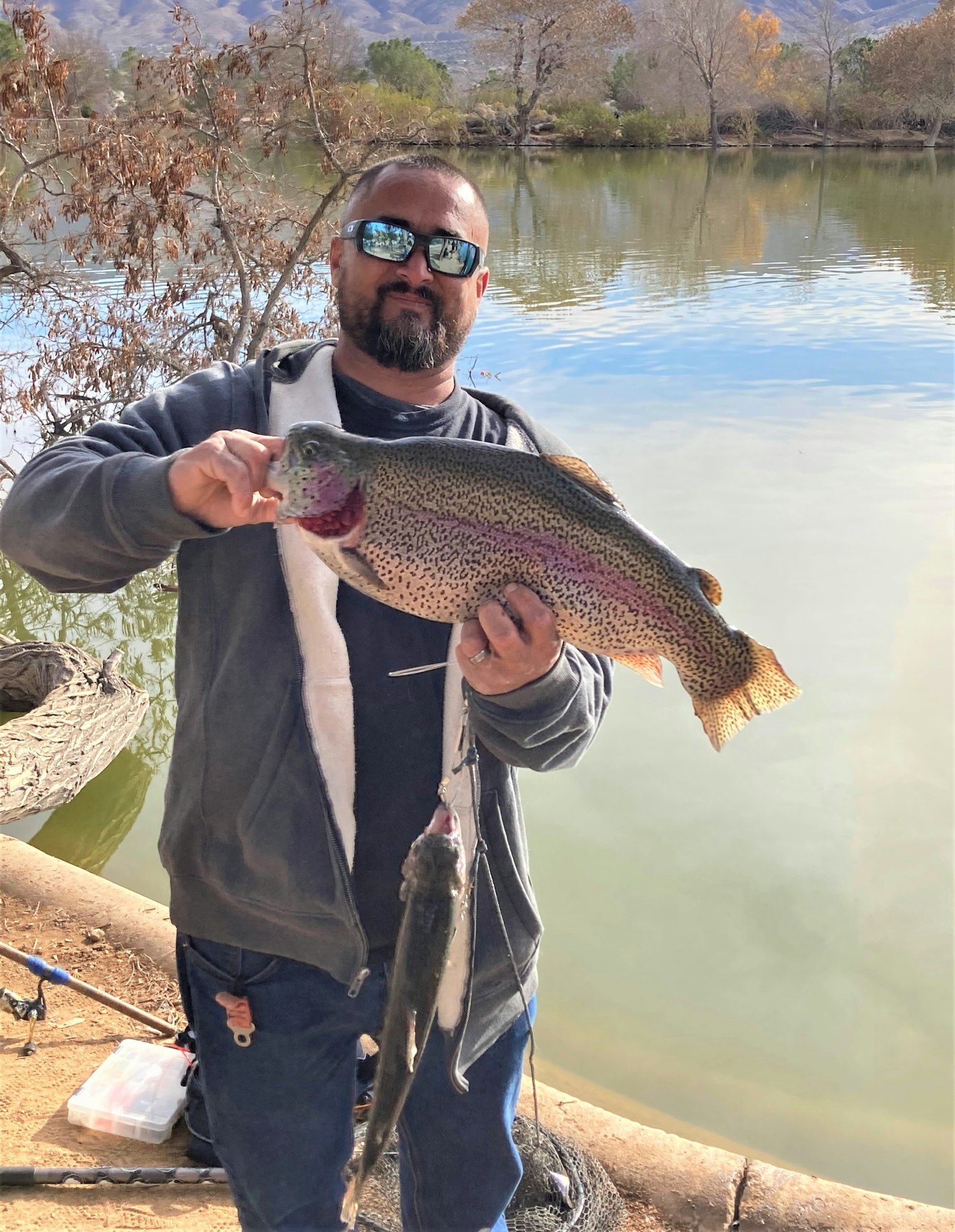 May contain: portrait, photography, person, head, face, trout, fish, sea life, animal, fishing, outdoors, water, leisure activities, ring, jewelry, accessories, man, adult, male, glasses, and sunglasses