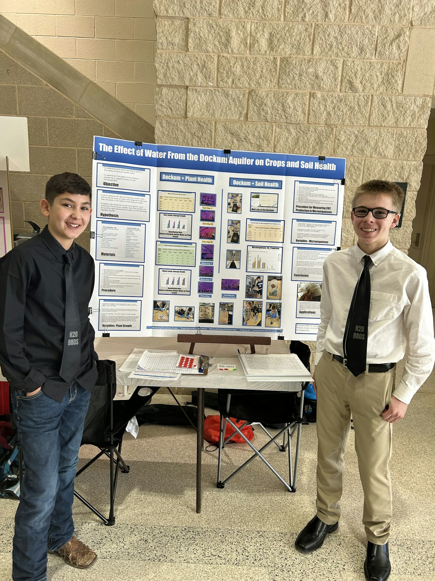Person posing by a science poster about "The Effect of Tile Drainage on Crops & Soil Health."