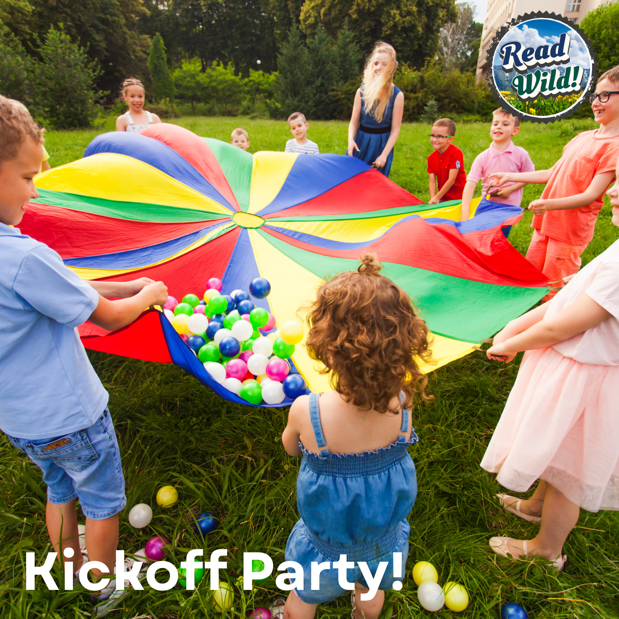 A lively outdoor kickoff party with children playing under a colorful parachute, surrounded by balls in a green field.