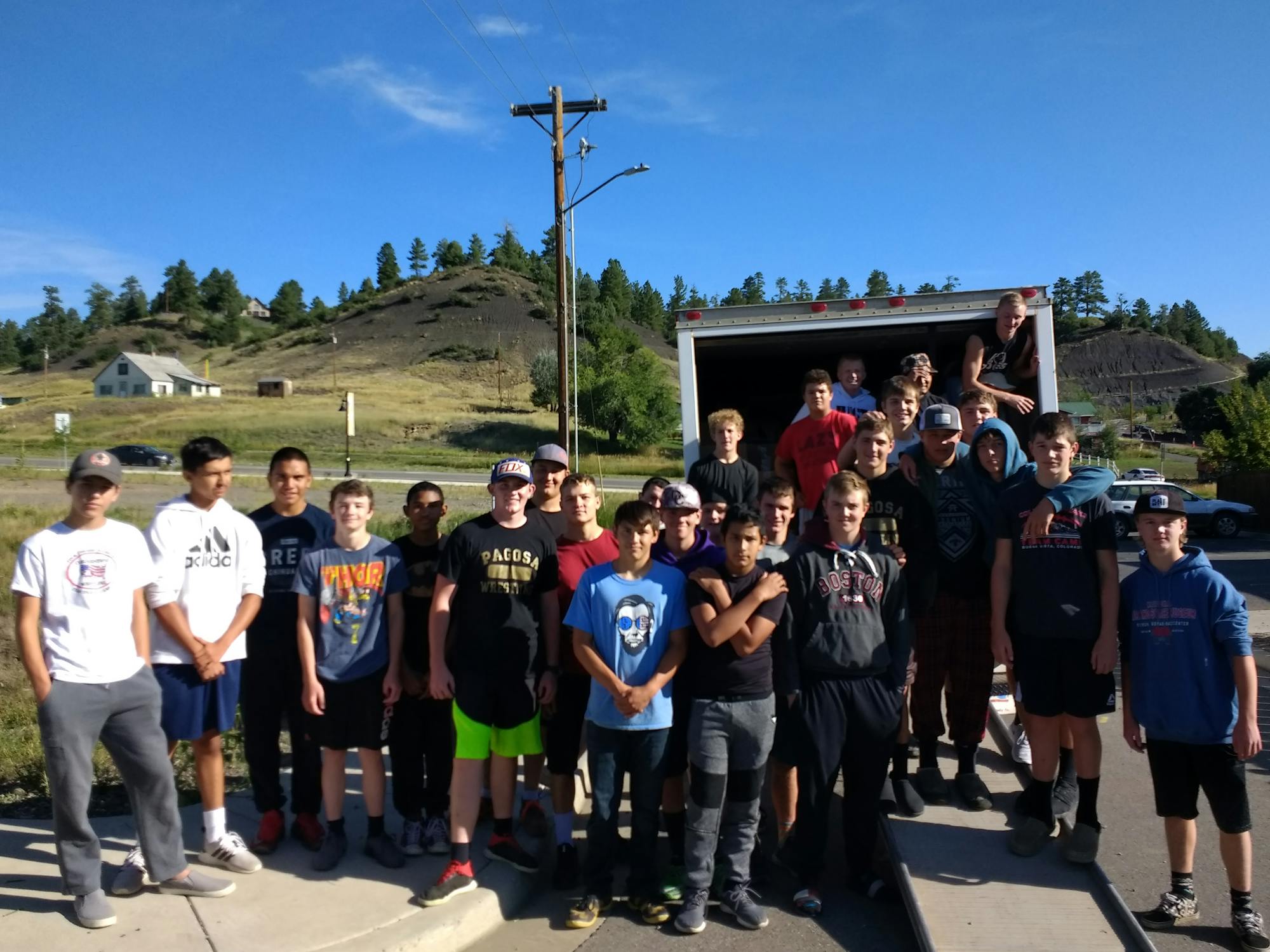 Member of the Pagosa Springs football team help load boxes of books for a book sale.