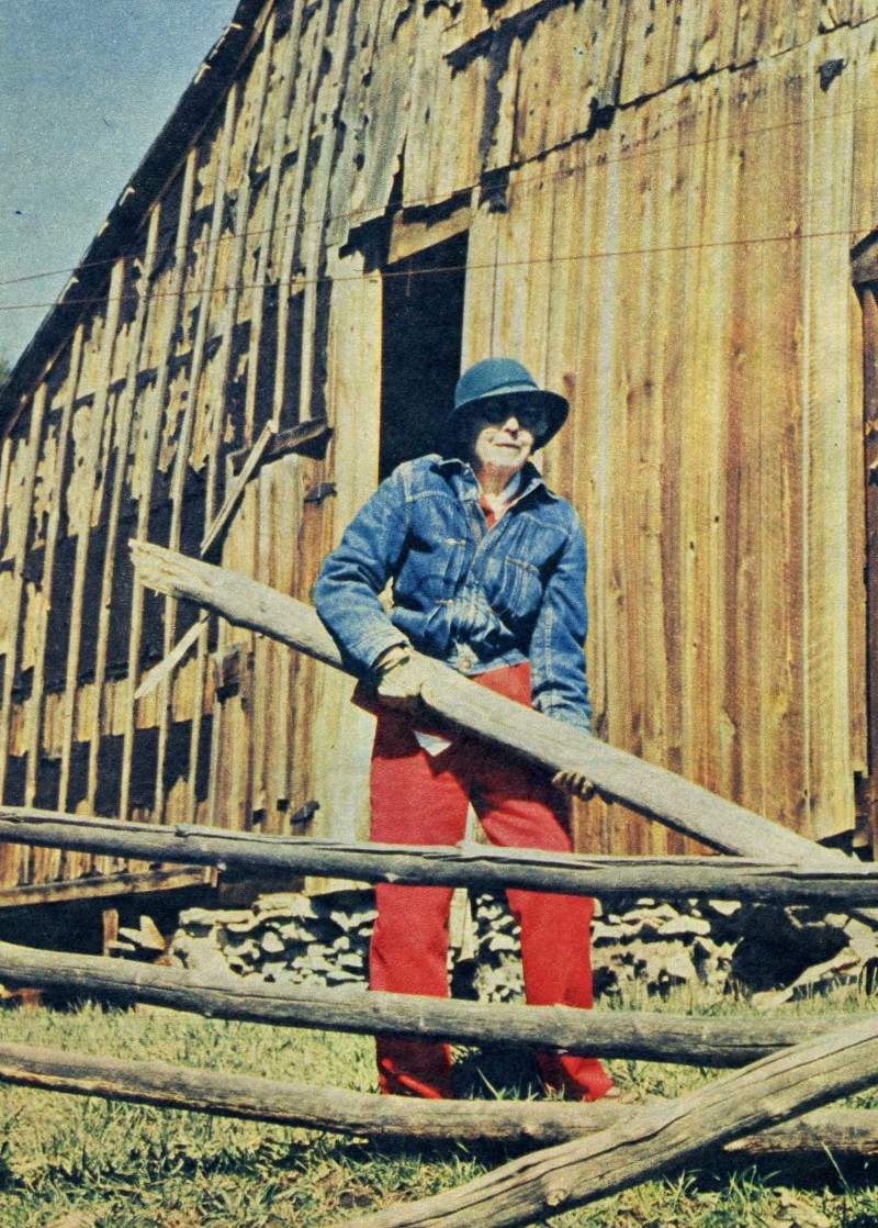 May contain: clothing, pants, face, head, person, photography, portrait, wood, architecture, building, outdoors, shelter, hat, nature, countryside, barn, farm, rural, and coat