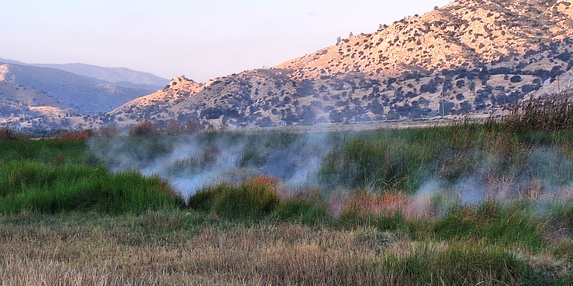 May contain: mountain, nature, outdoors, mountain range, and smoke