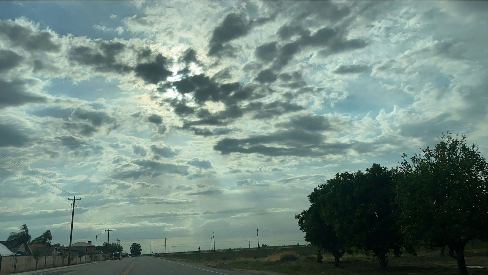 May contain: cloud, nature, outdoors, sky, road, cumulus, weather, landscape, scenery, utility pole, freeway, plant, tree, and vegetation