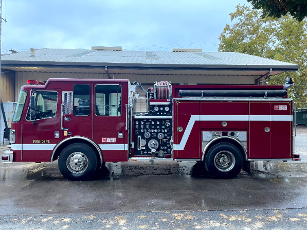 A red fire truck parked outside a building.