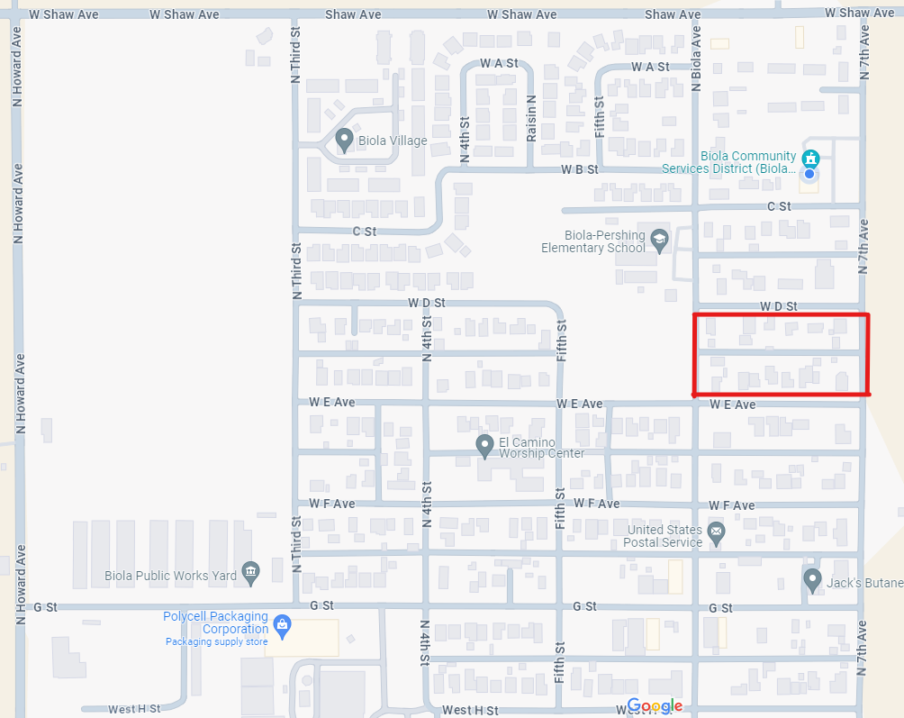 A map with streets, a highlighted area, buildings, and location markers.