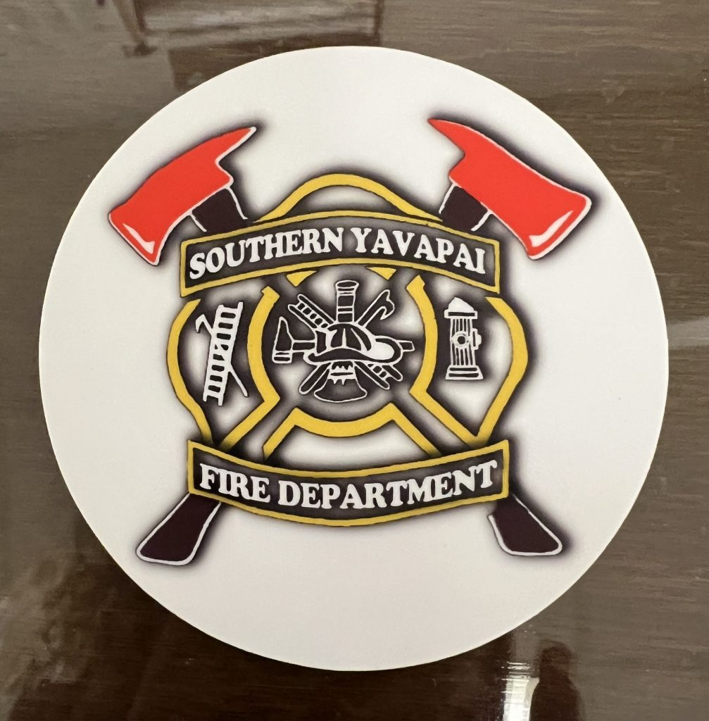 Southern Yavapai Fire Department logo with firefighting tools in a circular emblem.