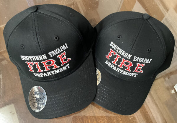 Two black caps with "Southern Yavapai Fire Department" embroidered in white and red.