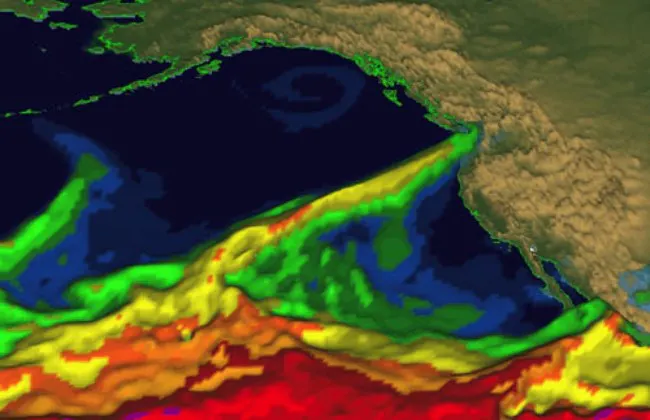 The image shows a colorful visualization of ocean temperatures and currents in a coastal region, likely around Alaska.