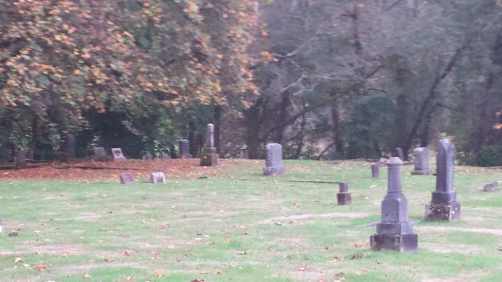 Photo of an old section of Maplewood cemetery in October with leaves in their autumn colers