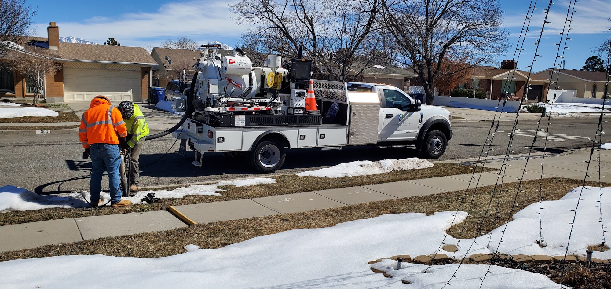 Water crew identifying water line material using a valve maintenance vehicle.