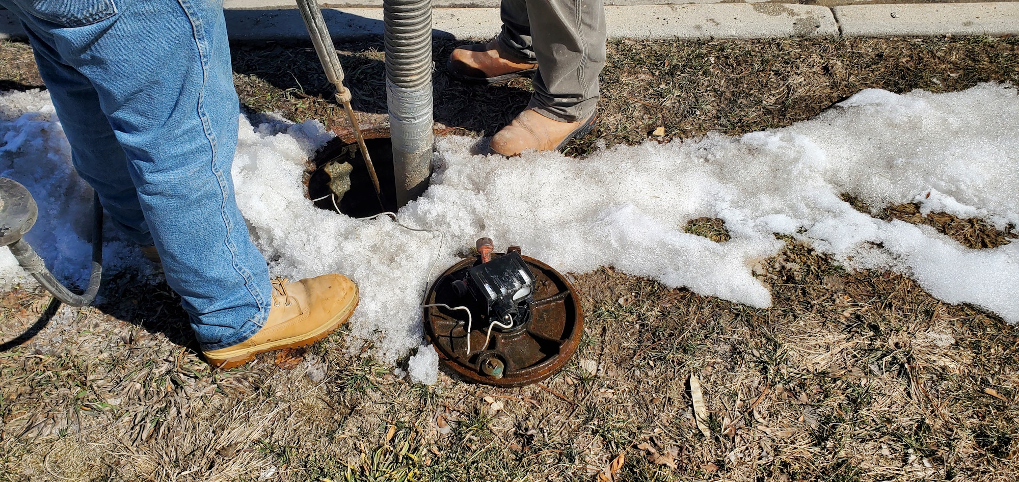 Water crew identifying water line material.