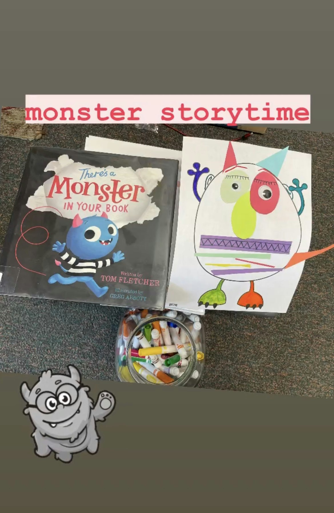 A children's book titled "There's a Monster in Your Book," a colorful monster drawing, and a jar of markers for creativity.