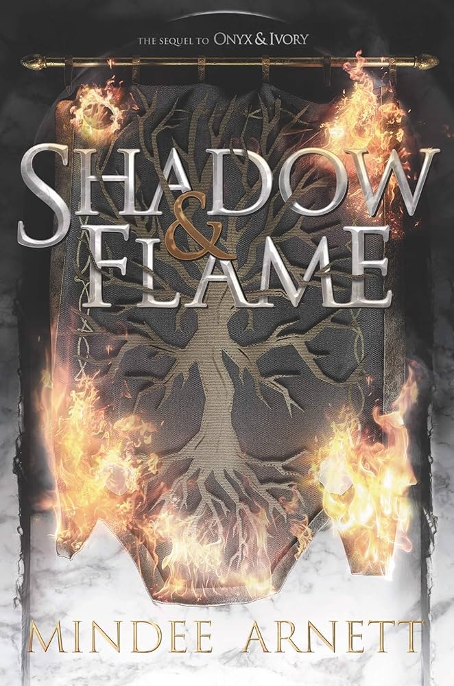 The cover of "Shadow & Flame" by Mindee Arnett, featuring fiery and shadowy designs with a sword at the top.