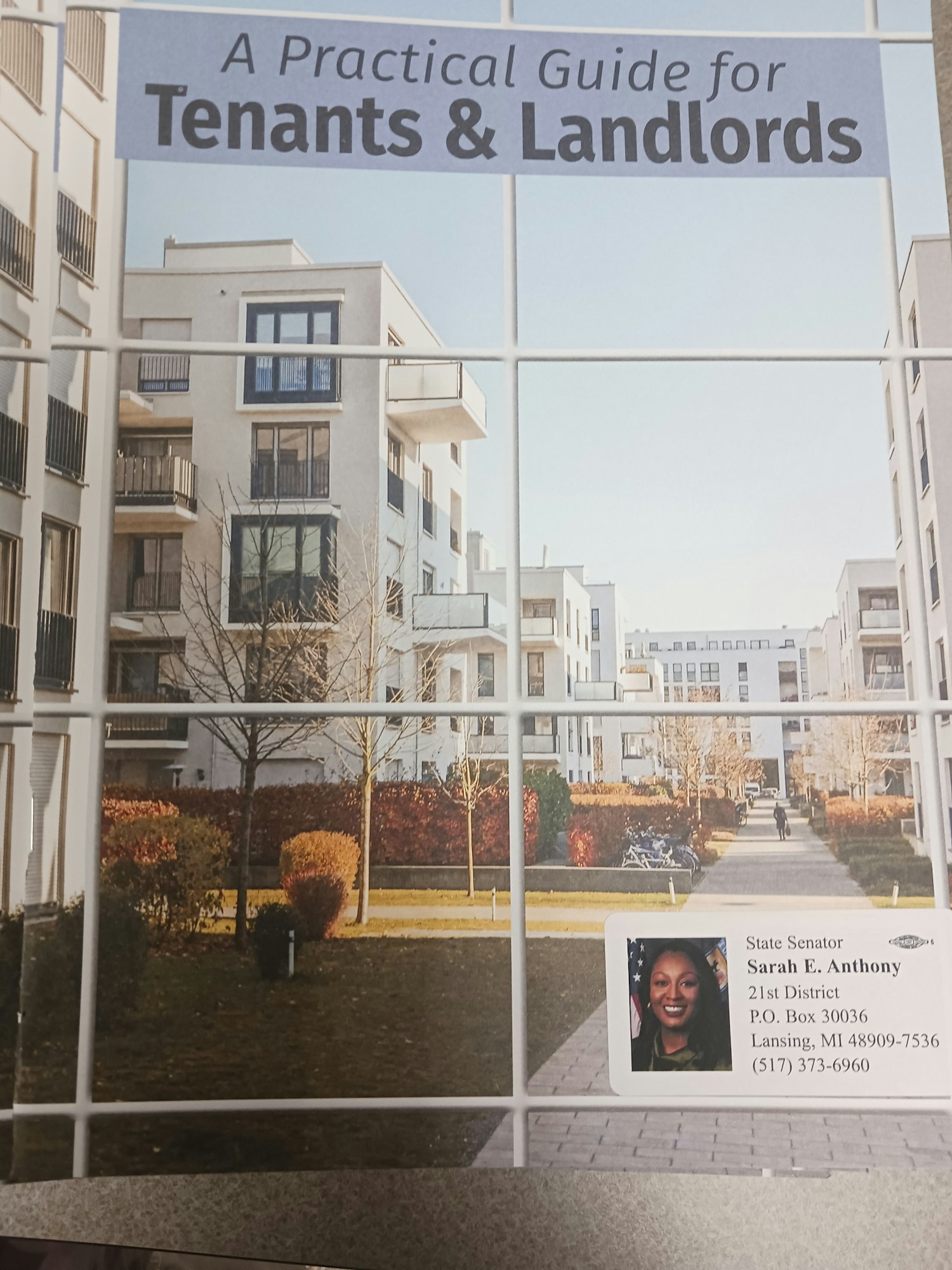 Cover of "A Practical Guide for Tenants & Landlords" with a cityscape image and a business card for a state senator.