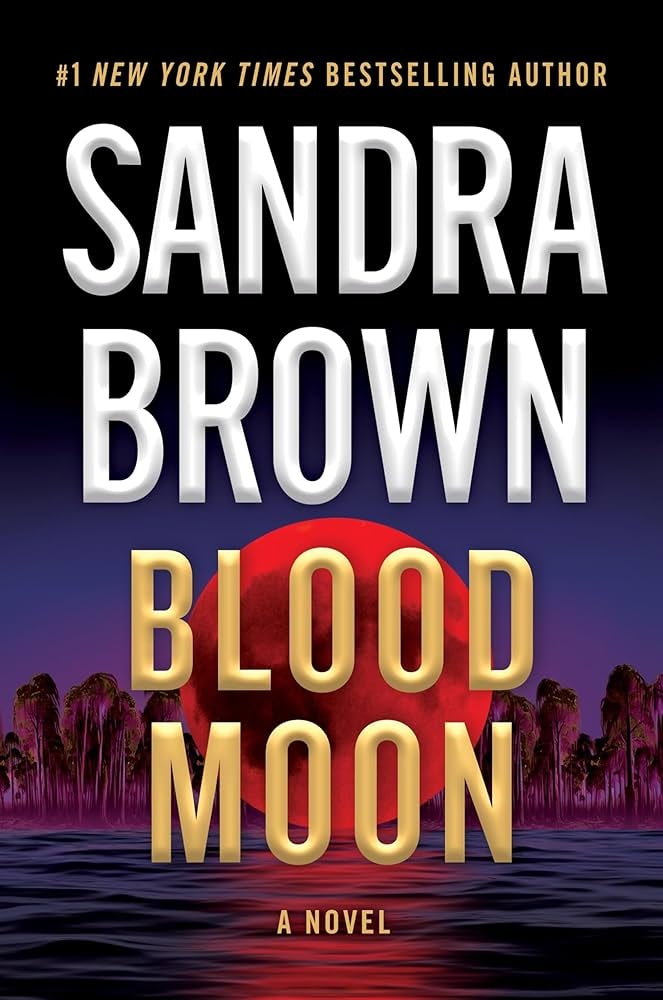 Book cover: "Sandra Brown - Blood Moon." Text with a large red moon and dark trees reflected in water.