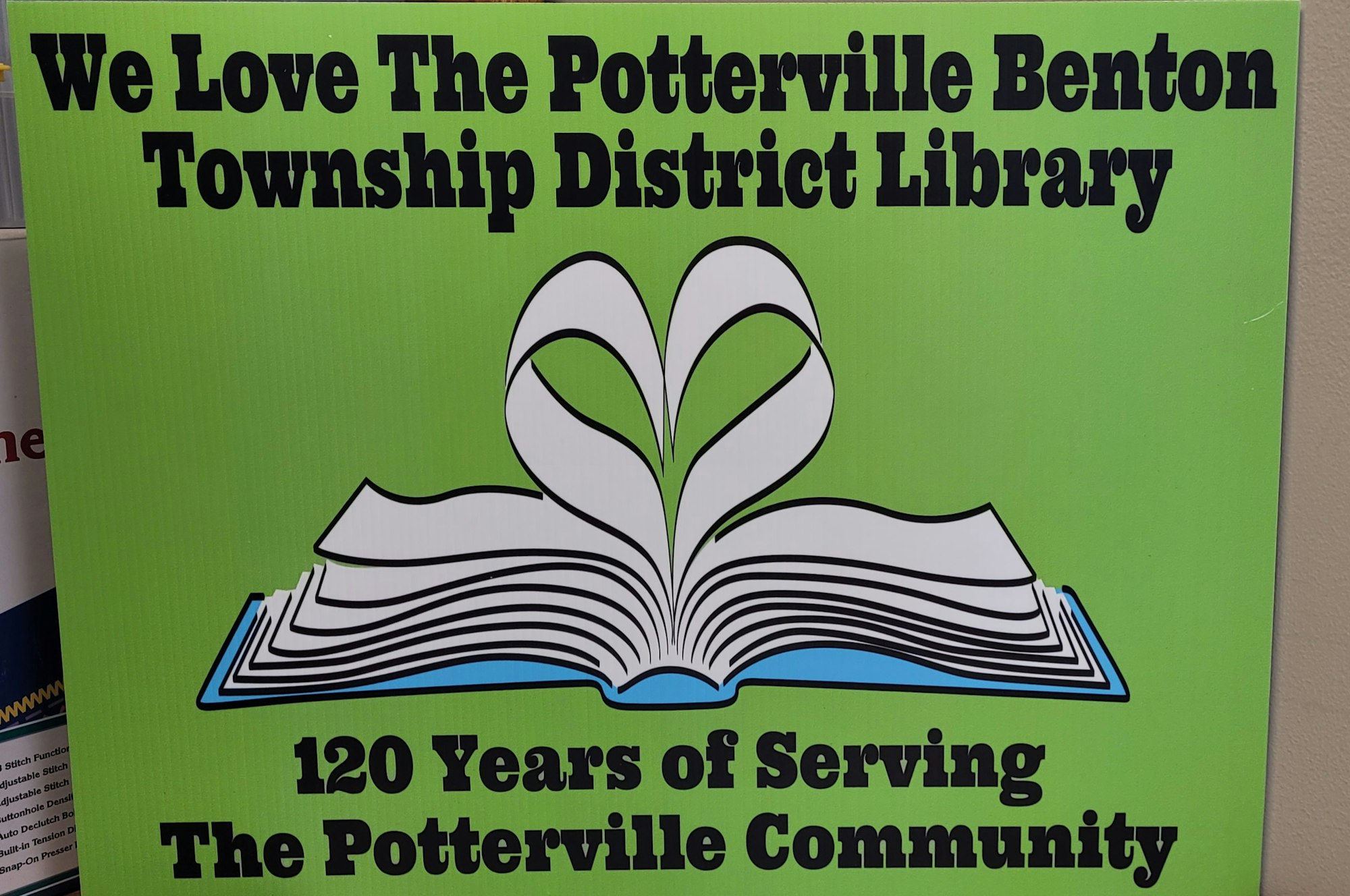 A sign expressing love for a local district library, commemorating 120 years of service to its community.