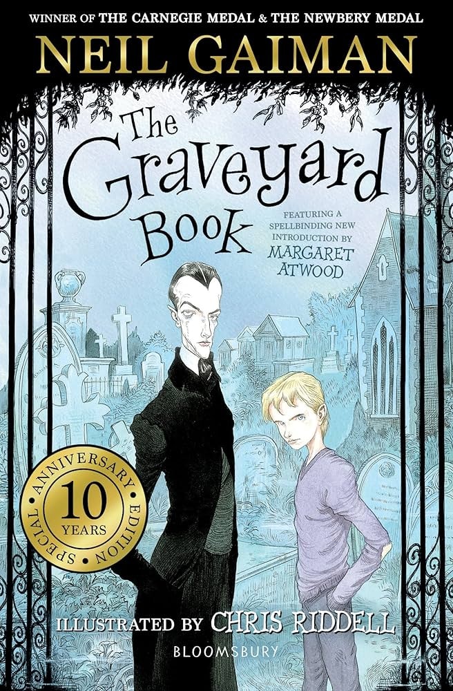 Book cover of "The Graveyard Book" by Neil Gaiman, illustrated by Chris Riddell, with two characters and a graveyard backdrop.