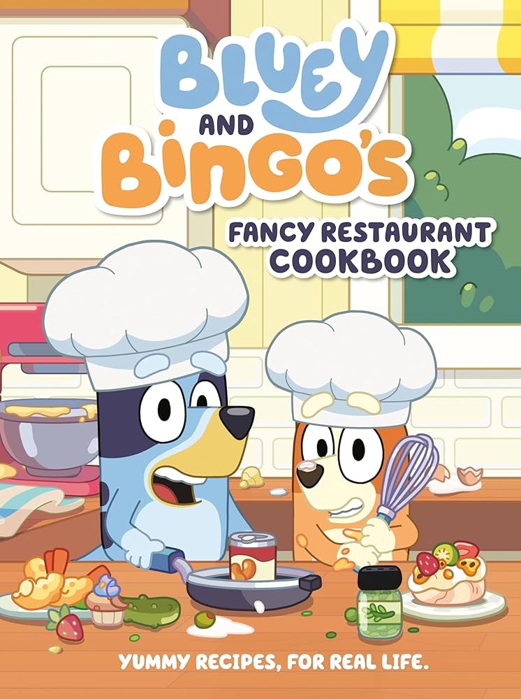 A cookbook cover featuring animated dog characters Bluey and Bingo in a kitchen, titled "Fancy Restaurant Cookbook."