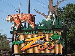 Potter Park Zoo sign featuring a tiger and a gorilla with leafy decorations.