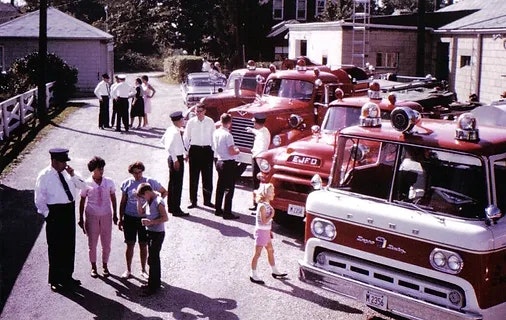 people standing next to vehicles