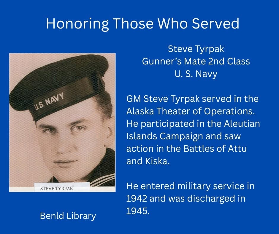 The image honors Steve Tyrpak, a U.S. Navy Gunner’s Mate, who served in WWII from 1942 to 1945 in the Aleutian Islands Campaign.