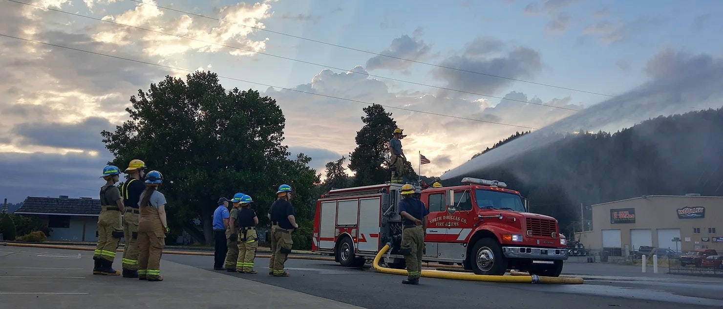 picture of a fire truck using their hose