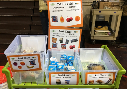 Food share bins with various items and a "Take it & Go!" sign promoting sharing and reducing waste.