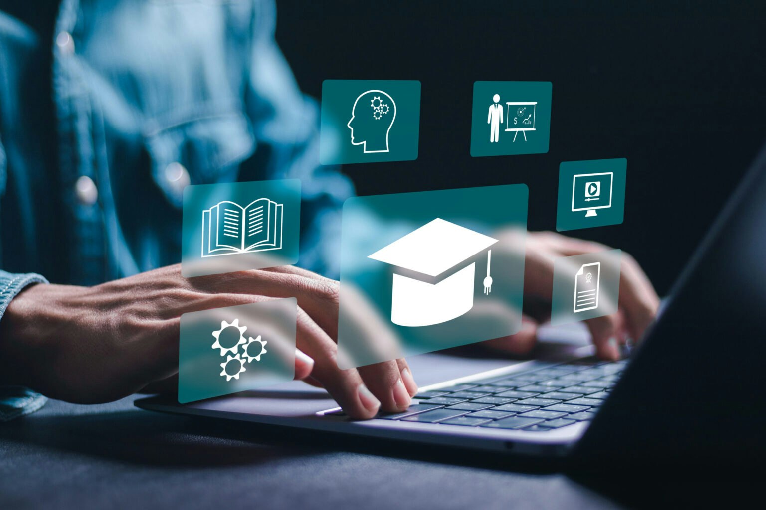 Person typing on a laptop with floating education-related icons, including a graduation cap, book, gears, and teaching symbols.