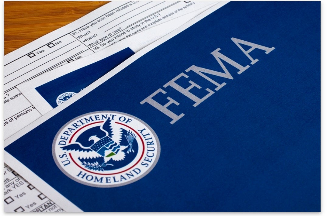 FEMA folder with a document, possibly an application form, featuring the U.S. Department of Homeland Security seal.