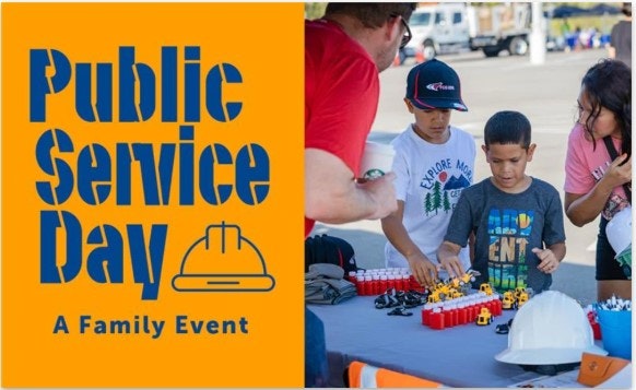 "Public Service Day" poster; kids and adults playing with toy vehicles at a table.