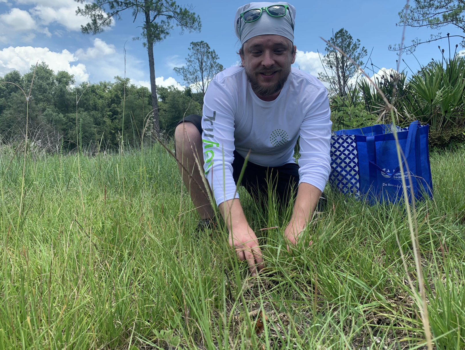 May contain: grass, plant, vegetation, herbal, herbs, field, grassland, nature, outdoors, soil, green, clothing, t-shirt, garden, tree, face, head, person, photography, portrait, gardener, gardening, wilderness, land, woodland, accessories, bag, and handbag
