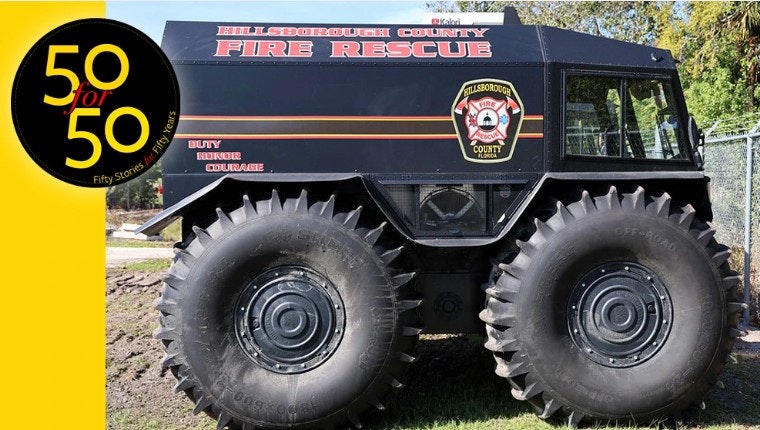 A large emergency vehicle with "Hillsborough County Fire Rescue" marking and massive tires, parked outdoors.