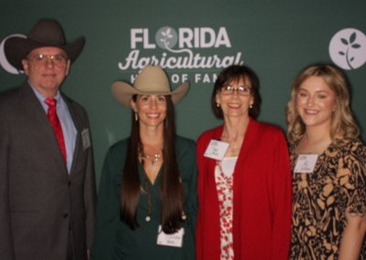 Four people in formal attire stand in front of a "Florida Agricultural Hall of Fame" backdrop.