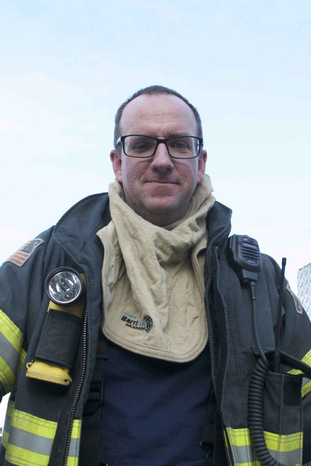 May contain: jacket, clothing, coat, apparel, person, human, glasses, accessories, accessory, and fireman