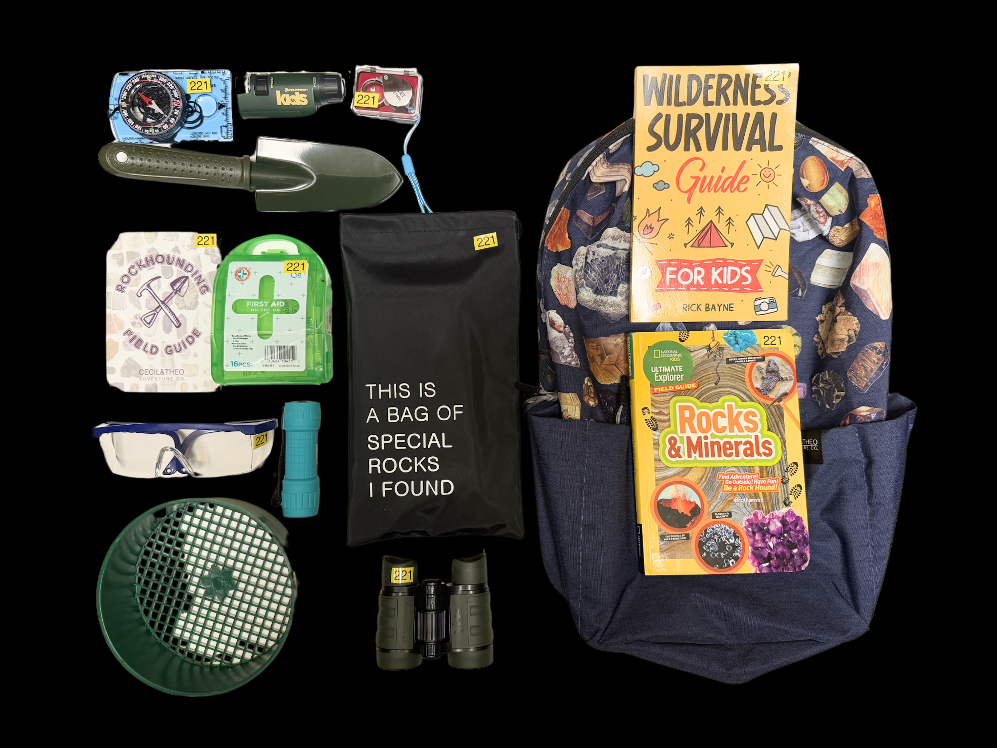 A backpack with a survival guide, binoculars, hand shovel, flashlight, first aid kit, and a bag labeled for special rocks.