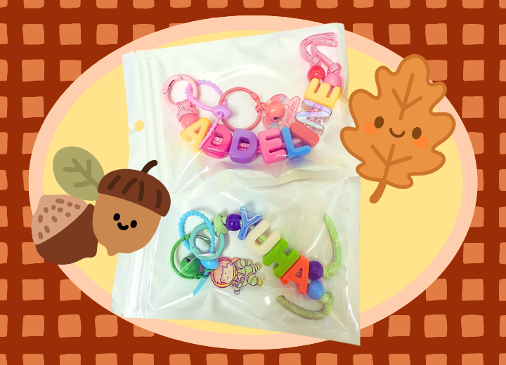 The image shows two sets of colorful, custom name keychains in clear bags, with playful autumn themed illustrations in the background
