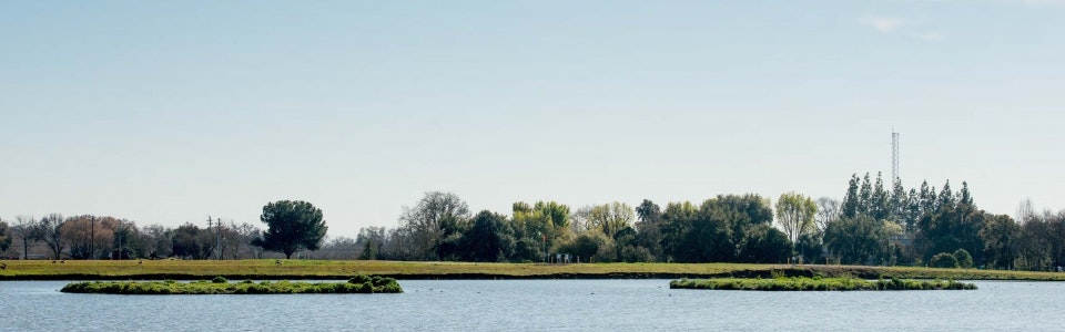 May contain: nature, outdoors, scenery, landscape, land, pond, water, panoramic, plant, vegetation, lake, and tree
