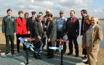Group of people at an outdoor ribbon-cutting ceremony.