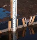 A water gauge in a body of water showing the water level.
