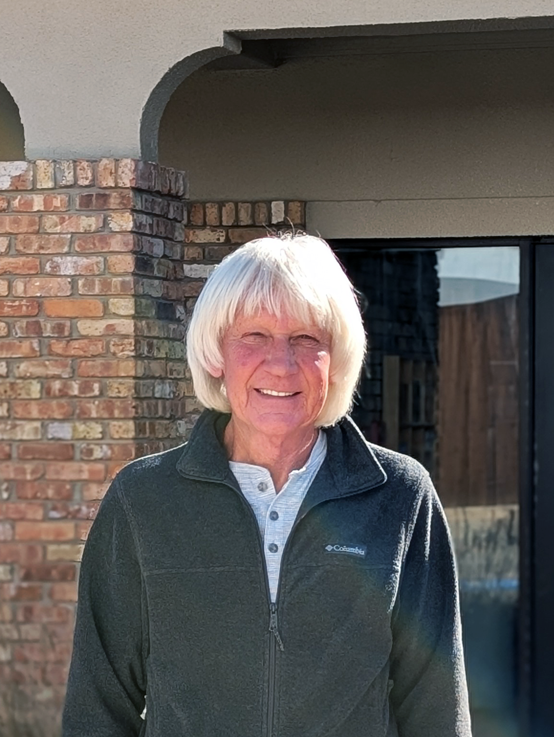 Bert Cooper smiling and standing outside the TCMUD Administration building.