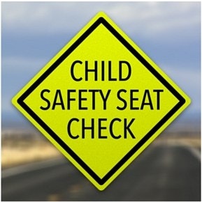 A yellow road sign that reads "CHILD SAFETY SEAT CHECK".